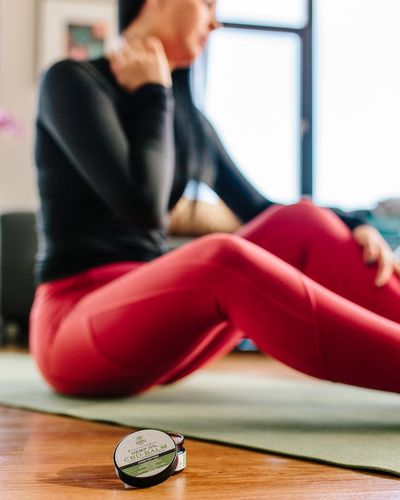 Close-up of exercise equipment, like a kettlebell, on a wooden floor.